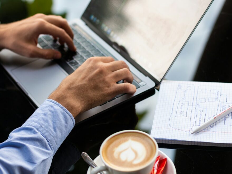 person in blue long sleeve shirt using black laptop computer